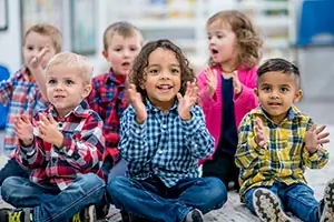 Group of children clapping and smiling Group of children clapping and smiling