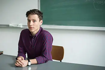 LGBT youth sitting at a desk