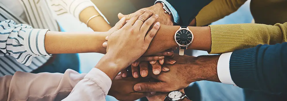 photo of many different hands clasped together
