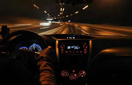 Photo of Caucasian male driving at night