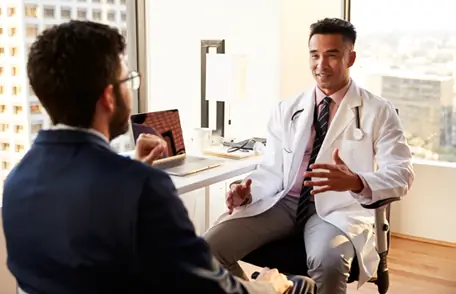Image of a young man talking with his doctor