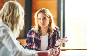 Image of a young woman talking with her doctor
