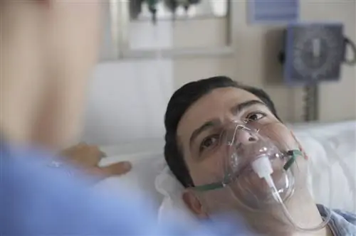 Мужчина в кислородной маске в больнице