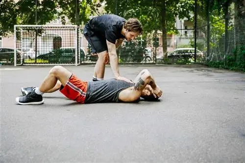 Мужчина лежит на футбольном поле